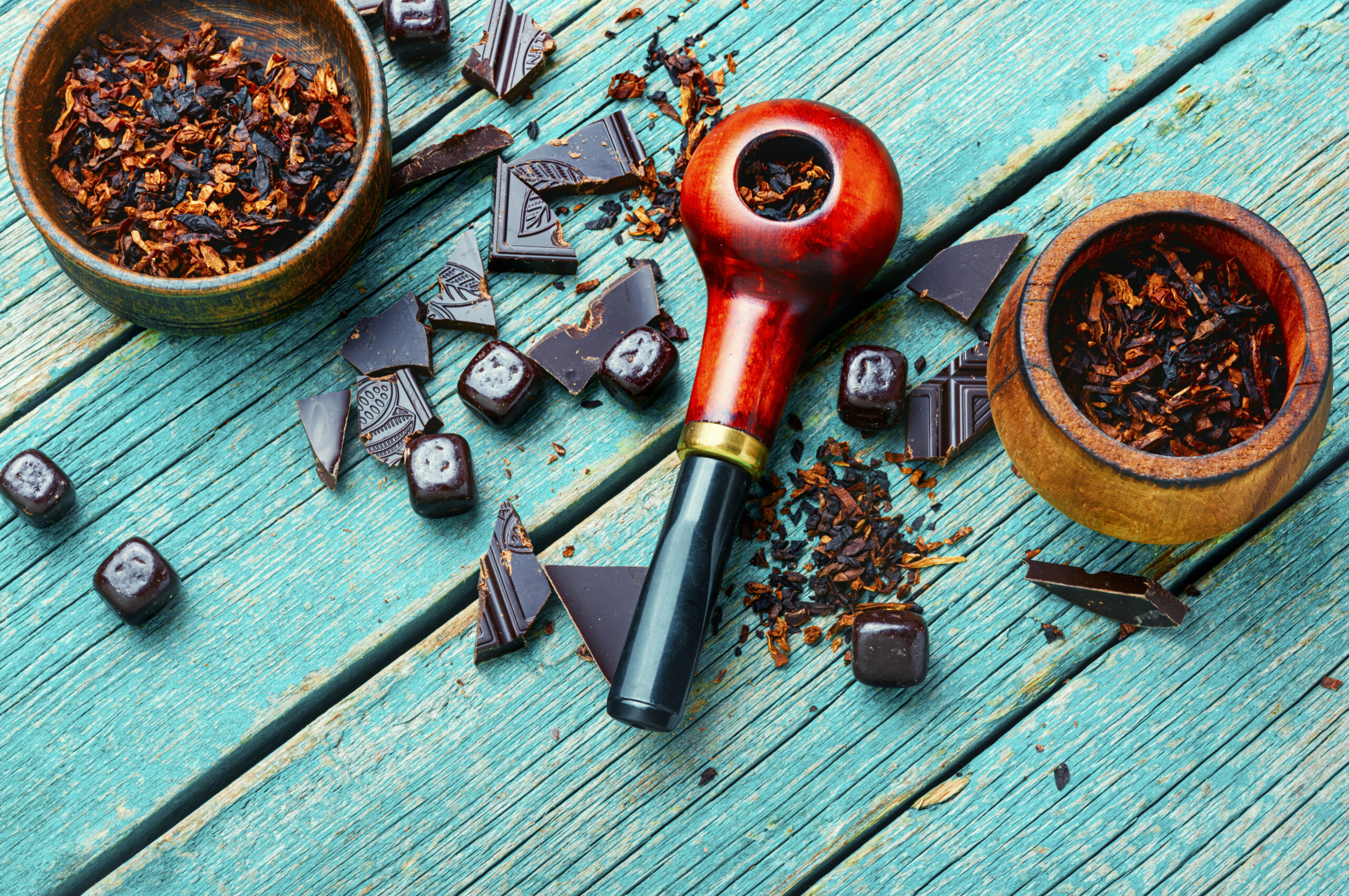 Chocolate tobacco for smoking pipes.Tobacco pipe filled with tobacco.Space for text